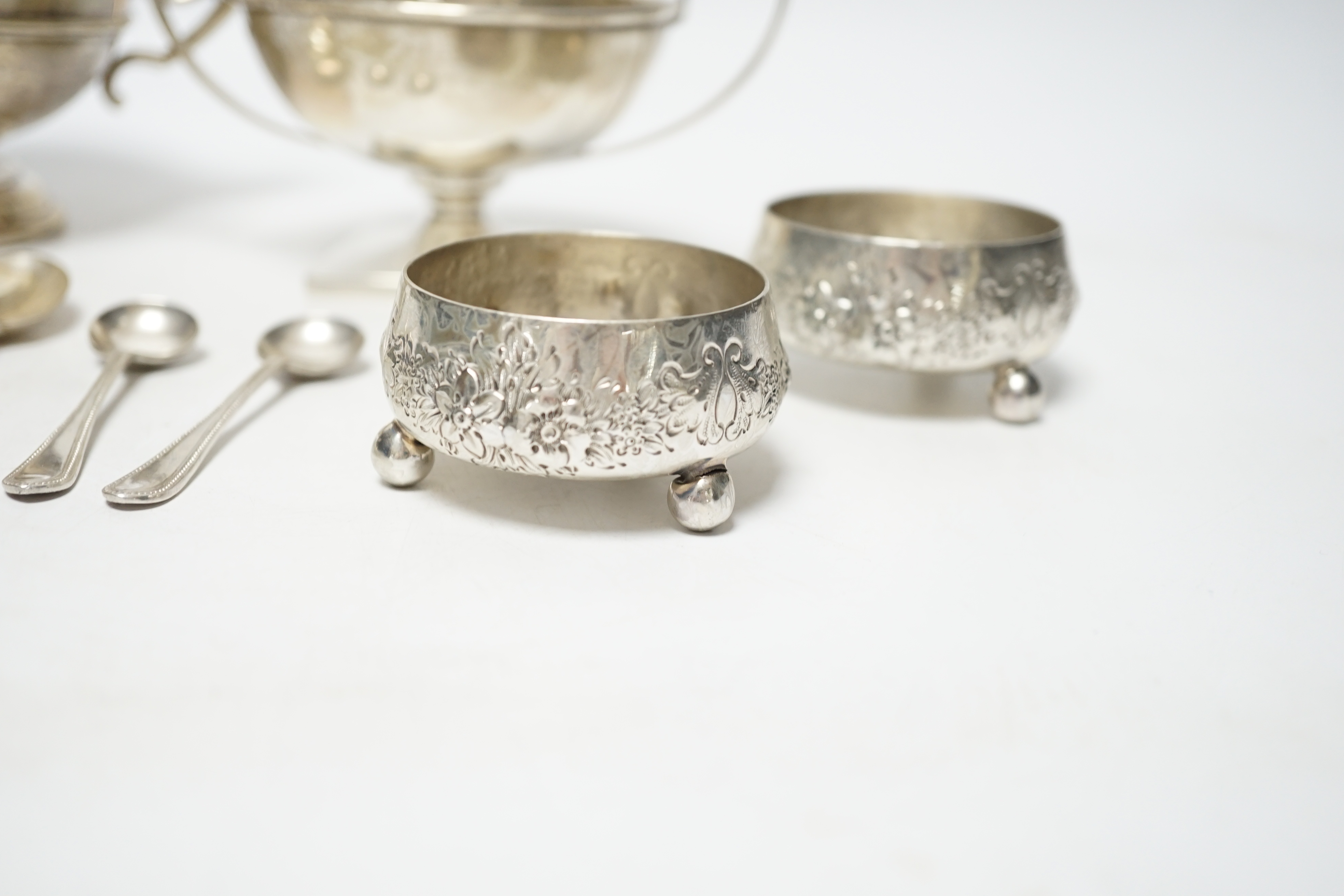 An Edwardian silver two handled bowl, Chester, 1902, diameter 10.4cm, a sterling bowl, a pair of engraved silver tub salts and matching salt spoons, Mappin & Webb, Sheffield, 1908 and a set of five silver teaspoons.